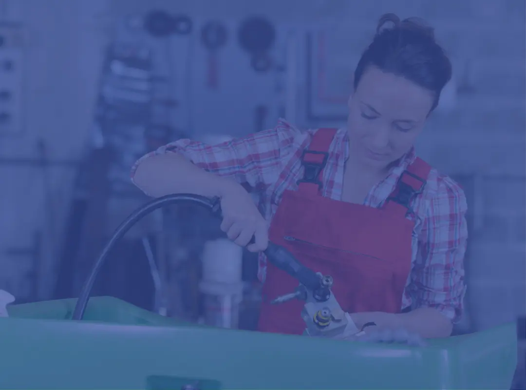 Female worker using parts washer (overlay)